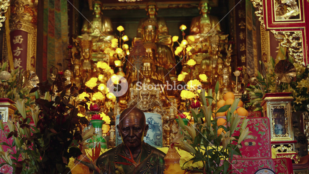 Buddhist shrine at Fansipan in Sapa, Vietnam, featuring golden statues, offerings, and warm lantern light, reflecting spiritual atmosphere and traditional Asian religious culture.