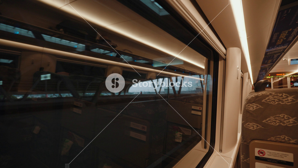 Jakarta, Indonesia - March 25, 2026: Interior of Whoosh high-speed train in Indonesia featuring modern passenger cabin, seating layout, and views from the window showing landscape and railway surroundings.