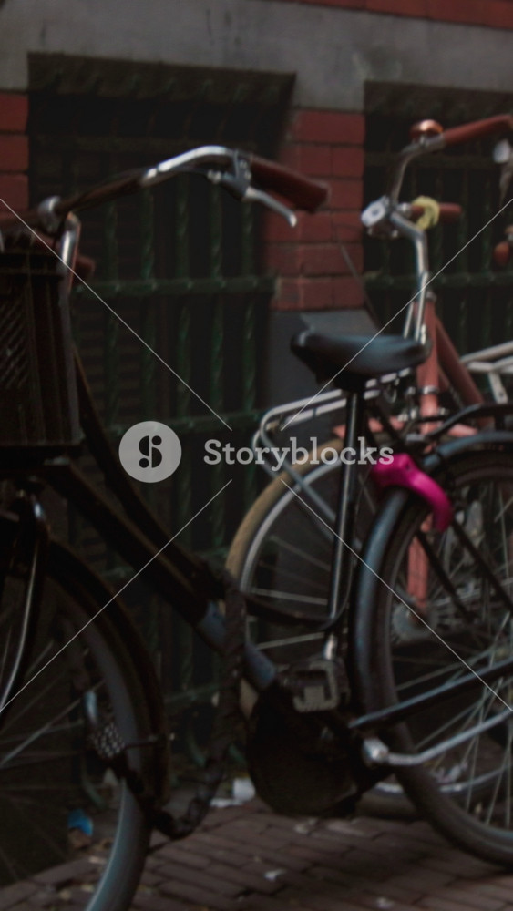 Vintage bicycles against wall, Evening scene of stationary city bicycles with wear and nostalgic city ambiance