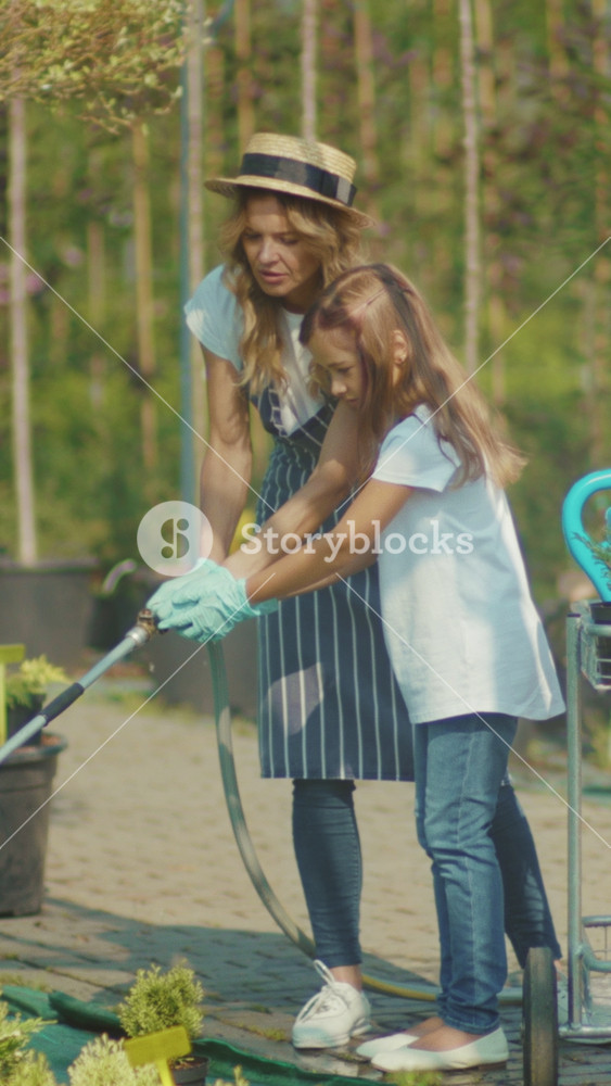 Family gardening scene, Family sharing peaceful moment nurturing flowers and seedlings in sunny outdoor space