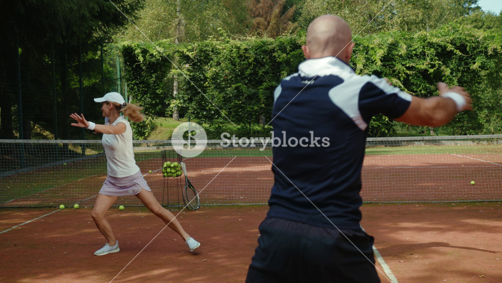 On sunny day players warm up before a game of tennis with trainer success match training course exercise fitness man woman athlete fun sport