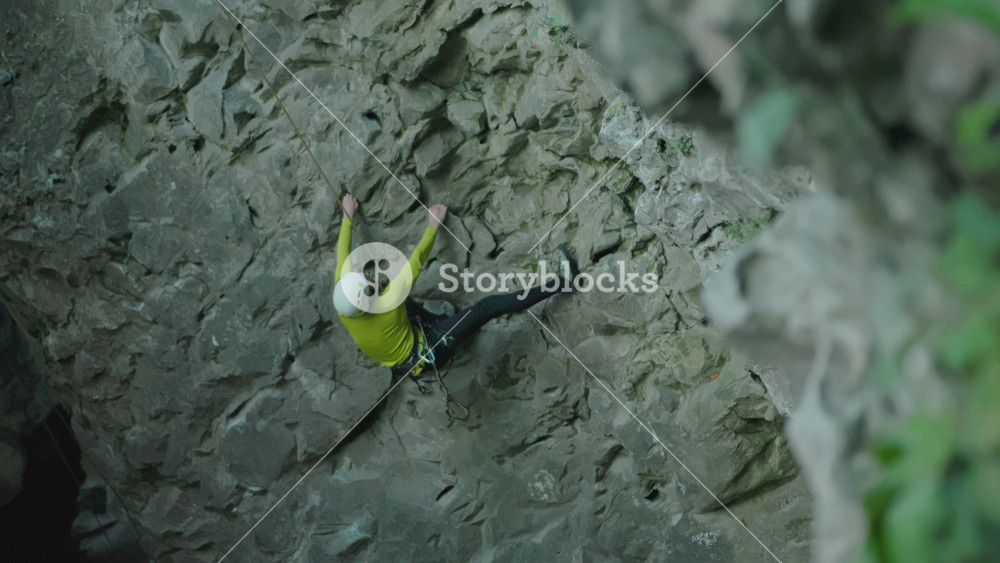 Extreme sports. Active alpinist male sportsman climbing down the mountain cliff limestone rock outdoor. Forest nature. Adventure.