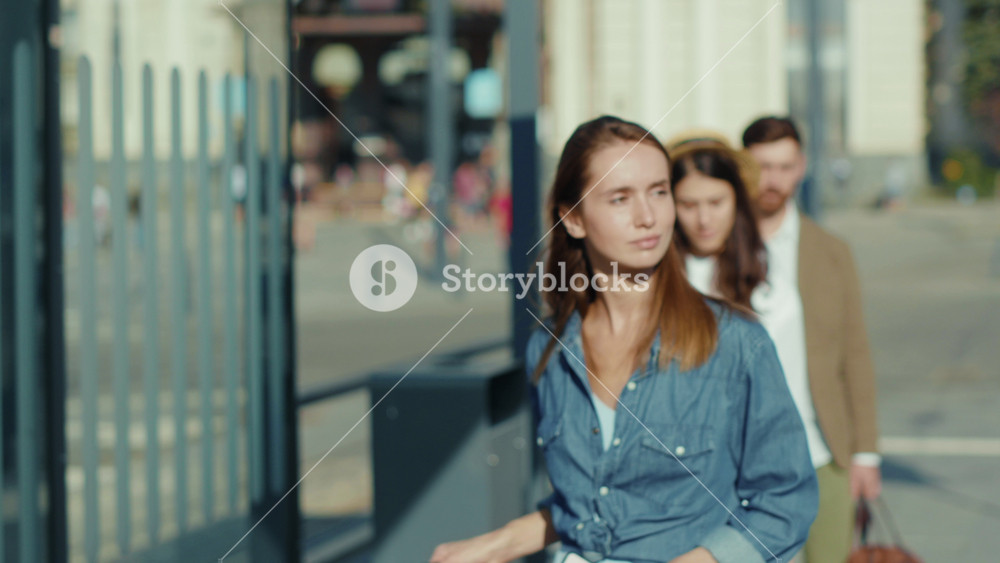 Close up mixed-races young males and females people standing in line at bus stop keeping safe social distance travelling street african