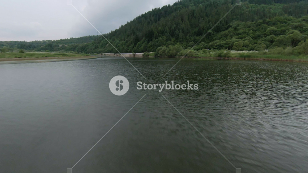 Inspiring natural shot of picturesque wide lake scenery with forest landscape. FPV drone shooting. Concept of inspiration, travel, journey