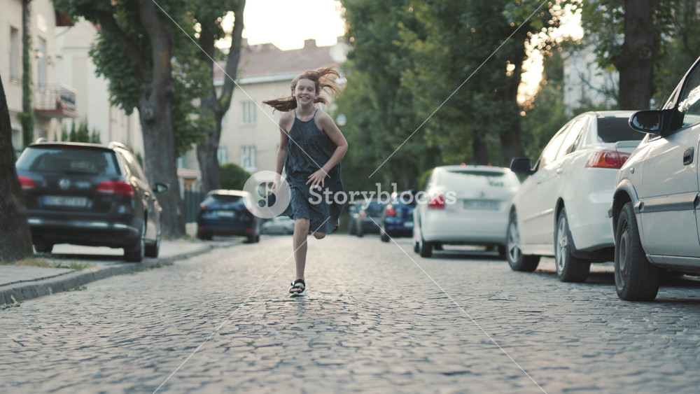 Cute fun teenage girl in green romantic dress running forward. Footage of amazing lady. Sport concept. Healthy lifestyle. Idea. Outdoors.
