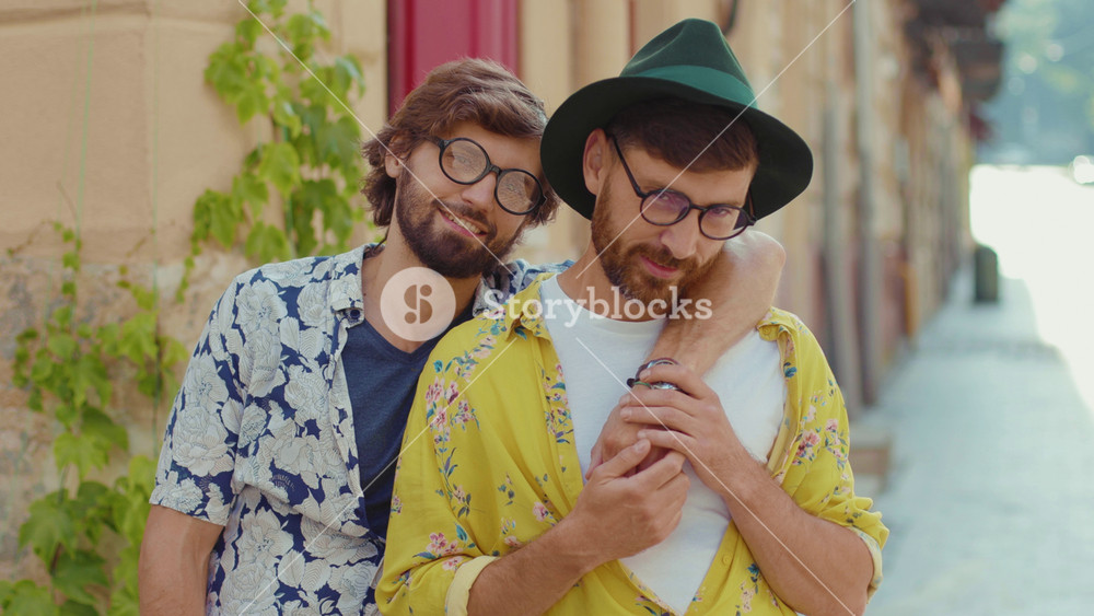 Portrait young two gay men look to camera feel happy couple dating LGBT relationship love smiling outdoors boyfriend attractive slow motion
