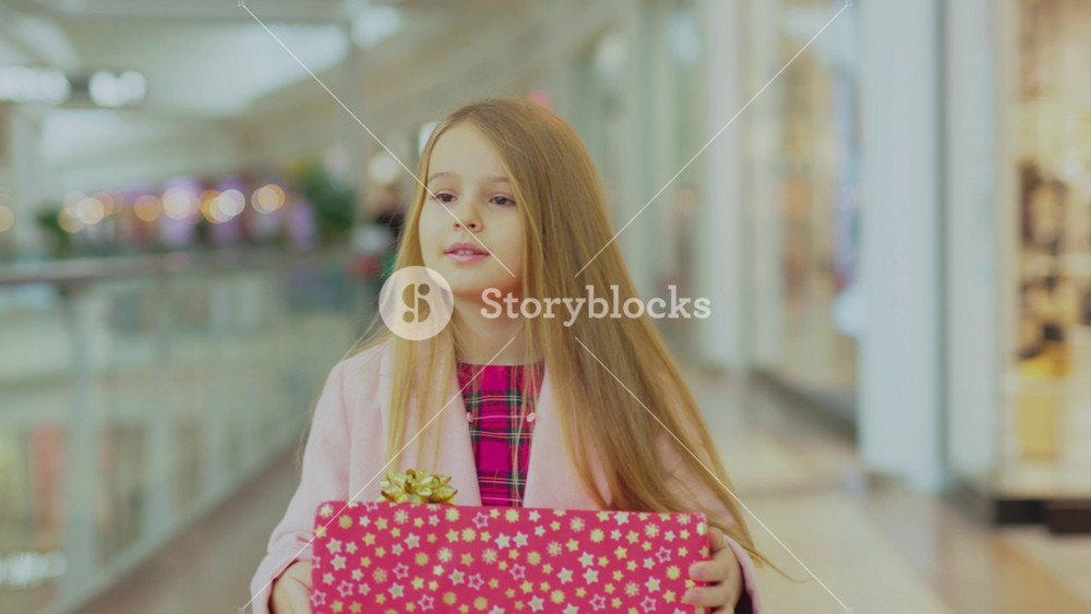 Cute smiling girl walk in the shopping mall with Christmas present boxes child family attractive teenager beautiful children cheerful