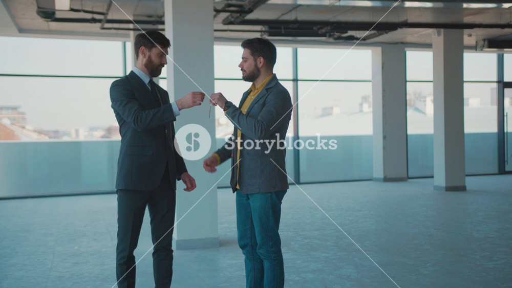 Shot of real estate agent gives the keys man shake hands smile client beautiful rent investment agent bright business mortgage sale empty