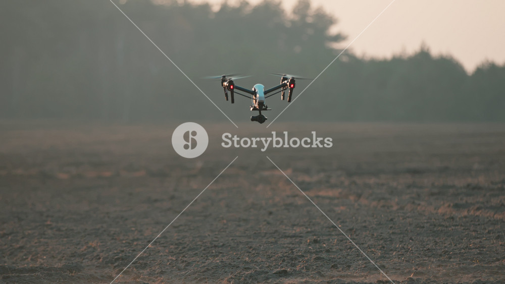 Drone field. Smart agricultural copter flying above farmland scanning territory monitoring harvest. Rural landscape. Industrial revolution