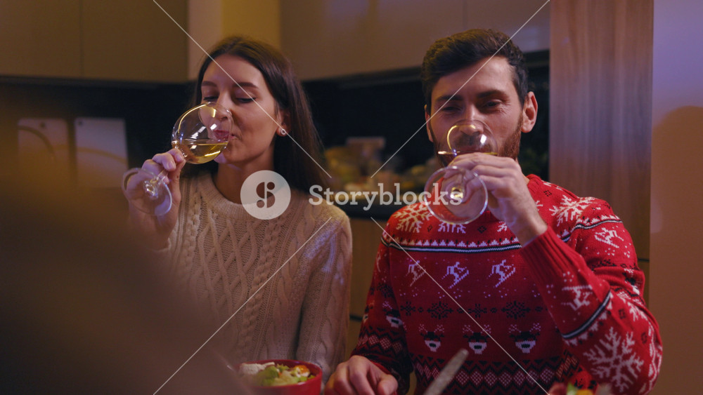 Happy family of five members toasting on Christmas dinner. Joyful couples of parents and kids celebrating winter holidays enjoying holy