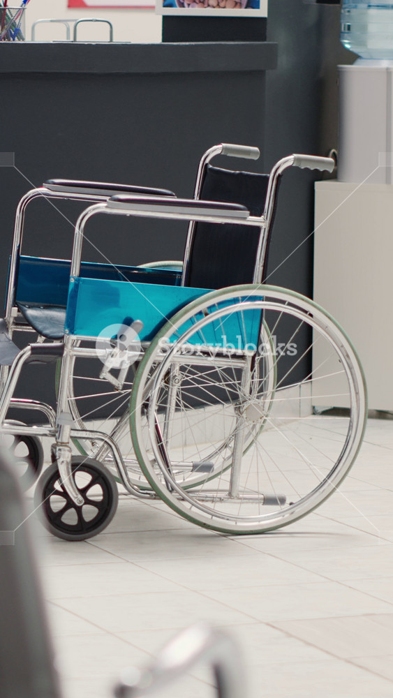 Vertical video: Empty front desk lobby with wheelchair in medical clinic, hospital reception area filled with seats and health care leaflets