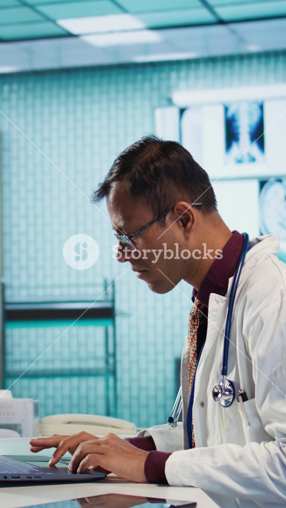 Vertical Video Young medical expert reviewing x ray test findings in medical office, providing a diagnosis for an ill patient. Physician