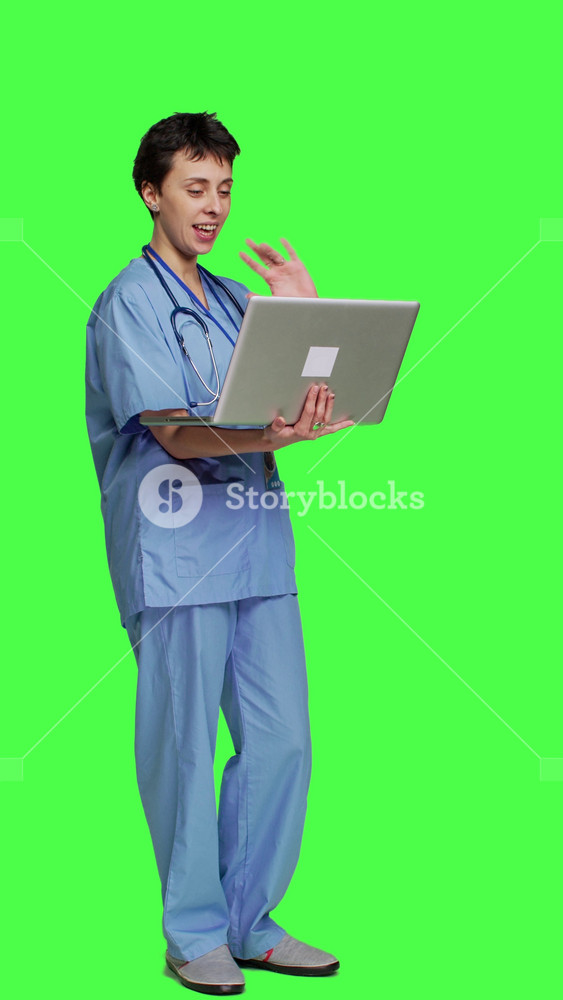 Side view Nurse attending online telemedicine videocall on laptop, talking to patients about disease diagnosis and treatments. Specialist