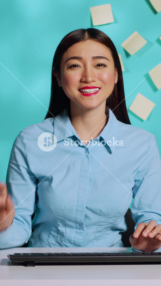 Cheerful professional businesswoman in online telemeeting videocall chating with coworker in bright colourful office. Smiling employee in