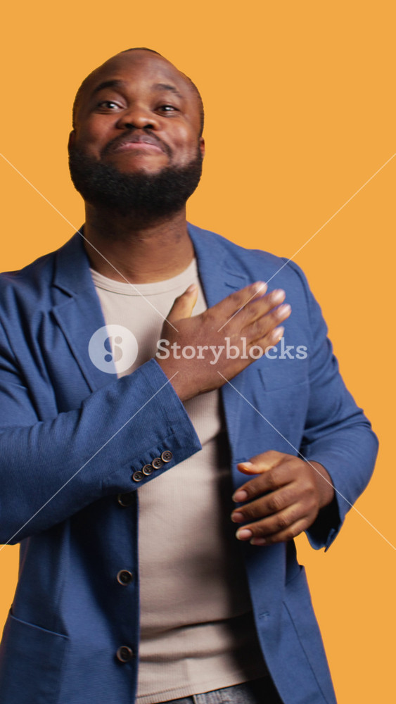 Vertical video Portrait of joyful cheerful african american man celebrating, showing positive emotions. Delighted BIPOC person thrilled by
