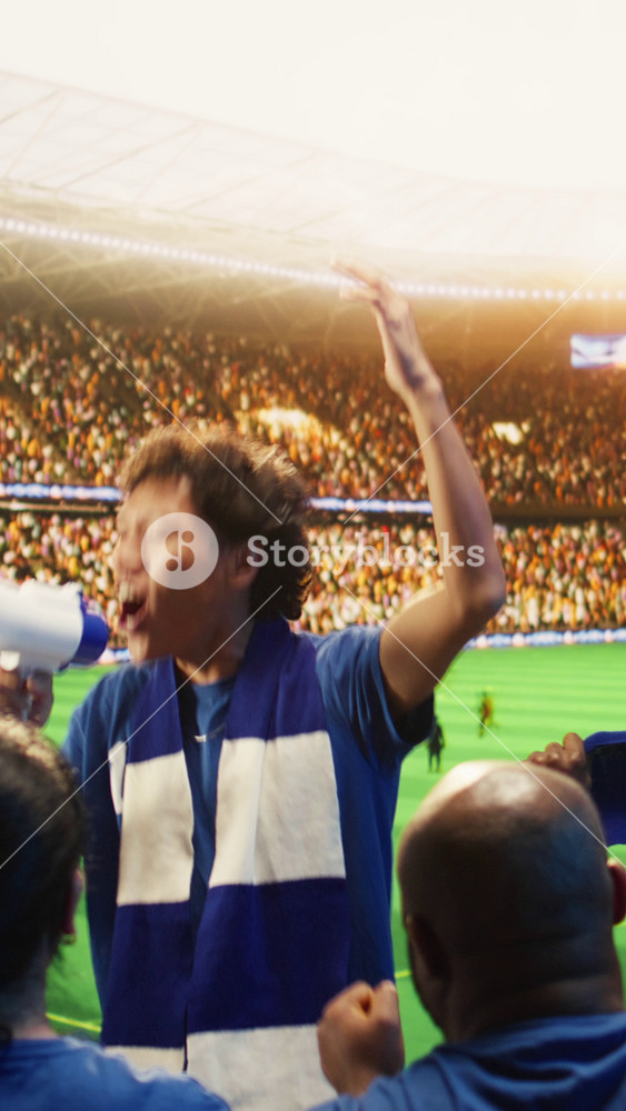 Vertical video Fanatical man on soccer stadium yelling in megaphone, cheering players. Ultras leader animating audience in sports venue