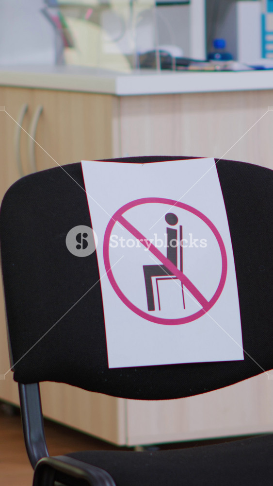 Waiting room in clinic with nobody in it, front office with new normal having sign on chair for social distance in coronavirus pandemic