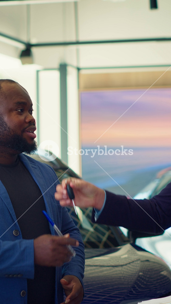 Vertical video Car dealership salesman giving sale contract for satisfied clients to sign after conducting test drive. Showroom agent