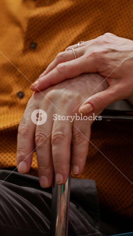Vertical Video Senior woman comforting her husband with impairment in wheelchair, elderly couple listening to guidance and professional