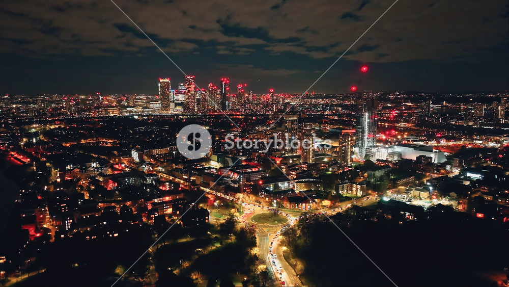 England, London: Breathtaking aerial view of night London city, highlighting the illuminated skyline skyscrapers and vibrant lights of