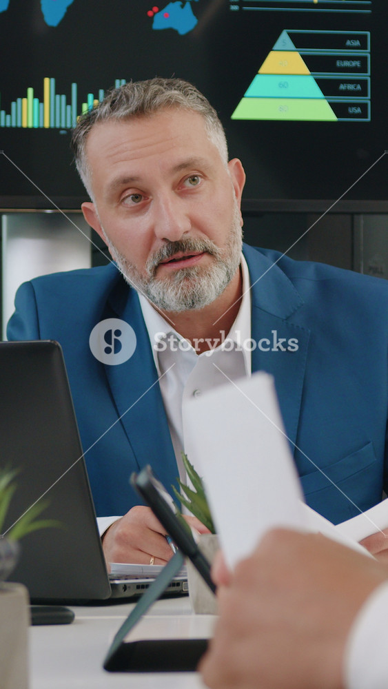 Multiracial business partners man and woman working together with their respected bearded chief over joint business strategy of company