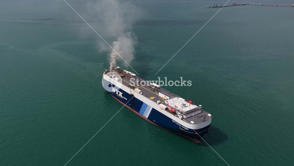 Laem Chabang, Chonburi Province, Thailand, February 10, 2026: Aerial view of a car carrier ship sailing in the open sea