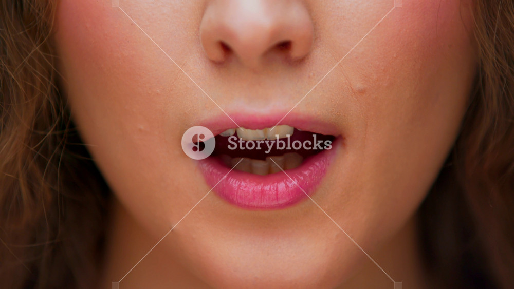 Portrait of Young Smiling Woman Showing Sign of Close Mouth and Shut Up on Camera Close Up. Face of Female Person Signing Stop Talking