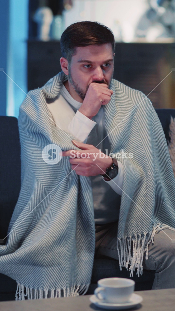 Caucasian Young Sick Adult Wearing Covering in Warm Blanket Recovering Illness Suffering Virus of Flu Staying Home Social Distancing