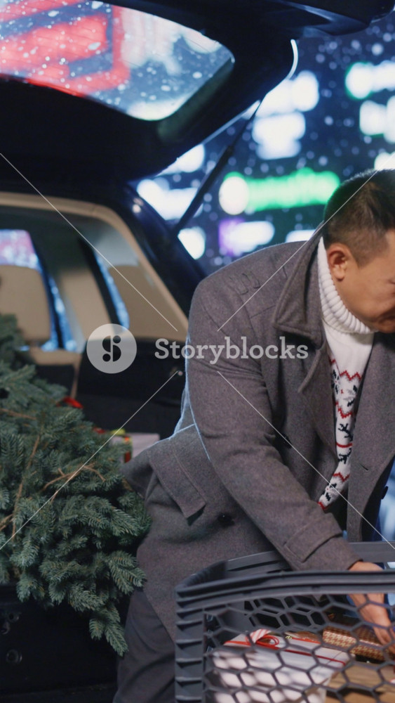 Diverse beautiful couple of married wife and husband packing presents in their car preparing holiday for family. Christmas is coming