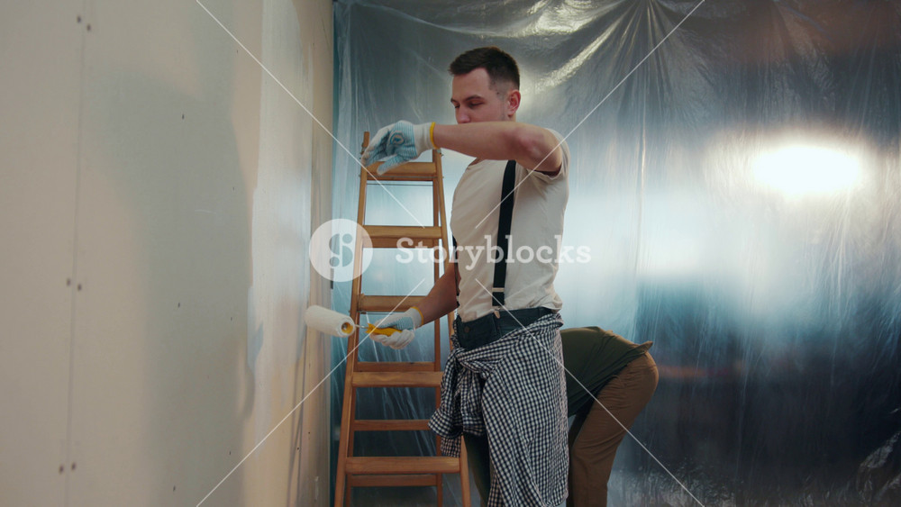 NEW YORK - April 5, 2017: Two skilled repairmen carrying out the reconditioning. One of the repairers wiping his forehead, his companion