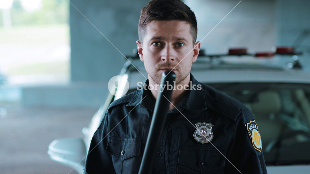 Serious young man cops stand near patrol car look at camera enforcement background his colleague happy officer police uniform auto safety