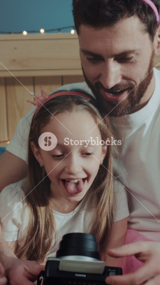 Father and daughter enjoying playful moment, Informal photograph capturing tender family bonds and cheerful expressions