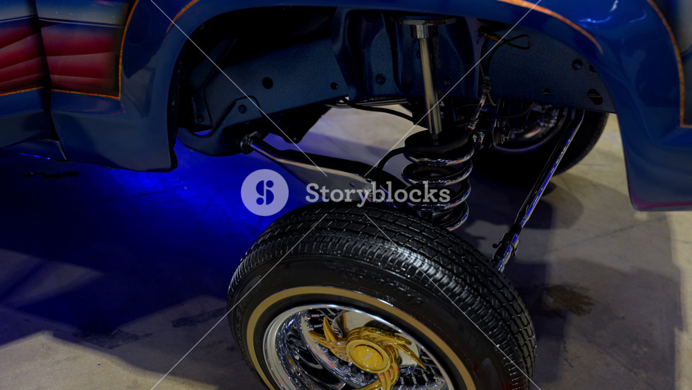 Classic lifted pickup truck with custom suspension and chrome wheels on display at indoor auto show. Lowrider style vehicle. Chicago IL. USA