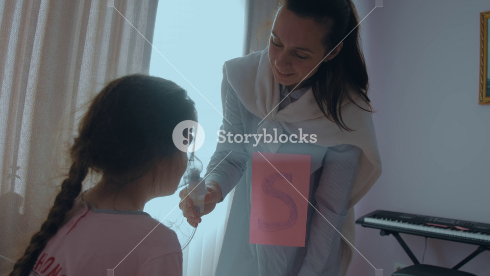 Loving mother with letter S on her chest and superhero cape is giving respiratory mask to treat sickness of her child. Mom with super powers