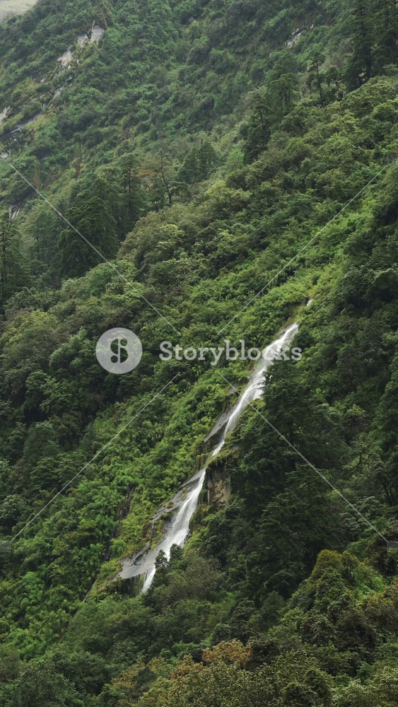 Vertical Waterfall in Mountains in Nepal in Nature, Vertical Video for Social Media Instagram Reels and Tiktok of Waterfalls in Green