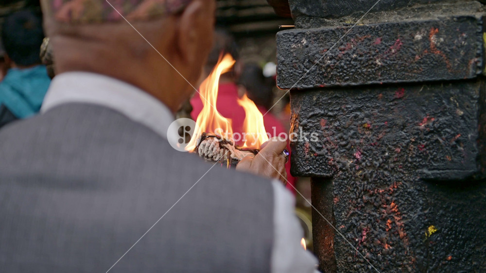 People Praying in Bhaktapur in Nepal, Person in Bhaktapur Ancient City in Prayer with Candles at a Temple, a Sacred and Holy Place in