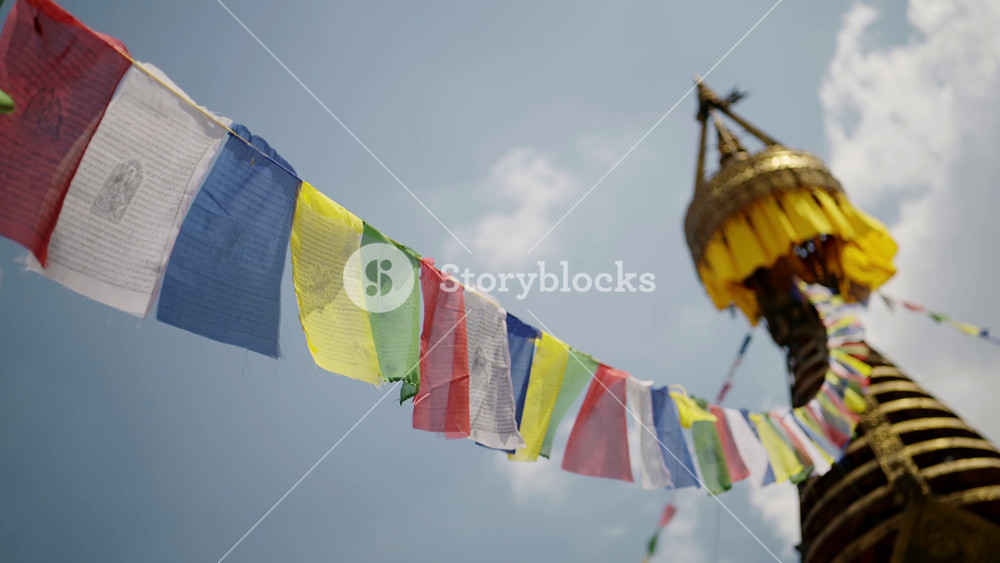 Buddhist Prayer Flags and Blue Sky at a Temple in Nepal in Kathmandu, Close Up Detail of a Gold Stupa and Colourful Tibetan Prayer Flags
