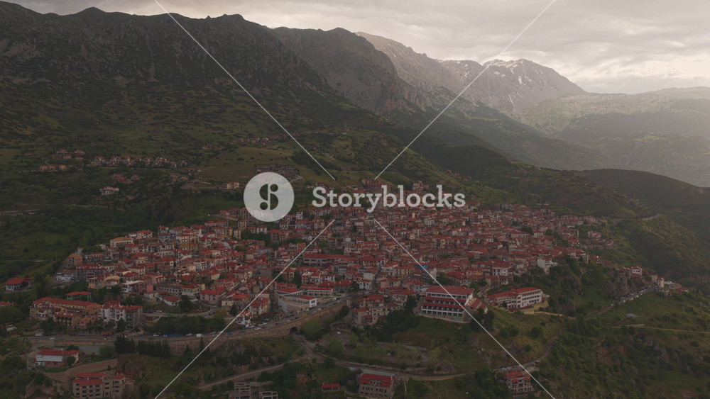 Beautiful aerial view of the traditional village of Arachova nestled on the slopes of mount Parnassus in Greece, with charming houses featuring red-tiled roofs and scenic mountain scenery
