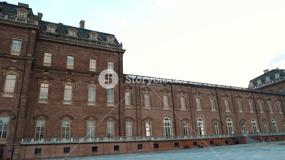 Wide view of the historic gardens at Venaria Reale Palace under a clear sky. Royal Savoy residence architecture in Italy.