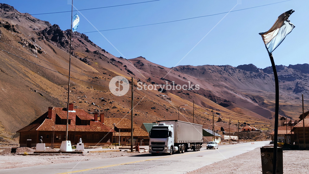 Las Cuevas, Argentina - March 20, 2020: Wide Landscape of Las Cuevas Mountain Pass with Argentine Flag and Traffic, Mendoza, Argentina - 4K