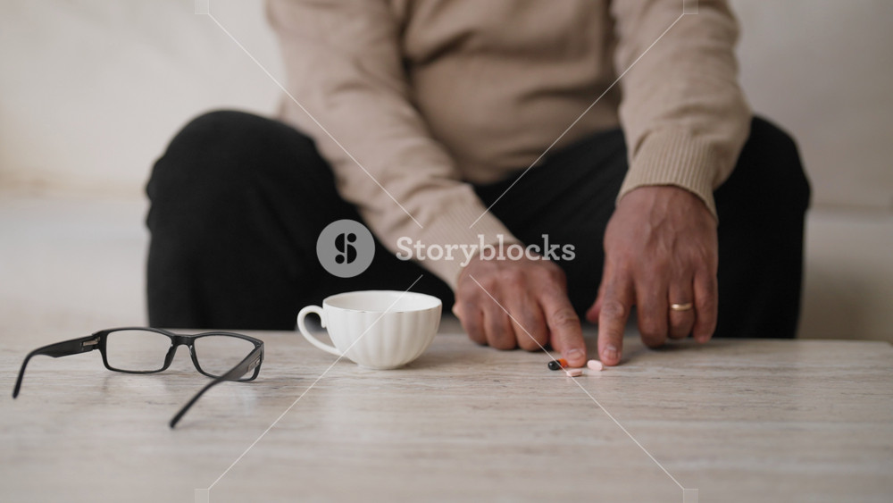 Mature man taking pills, details view of medicine and male body, better aging. Healthcare and modern medicament for curing and preventing