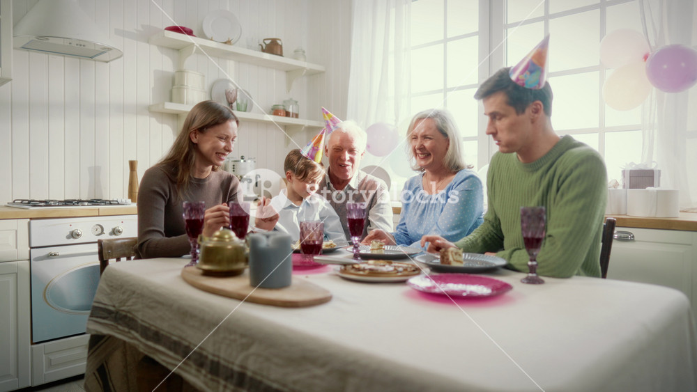 Little boy and his relatives celebrating anniversary and birthday at home. Portrait of happy family dinning together in weekend, three