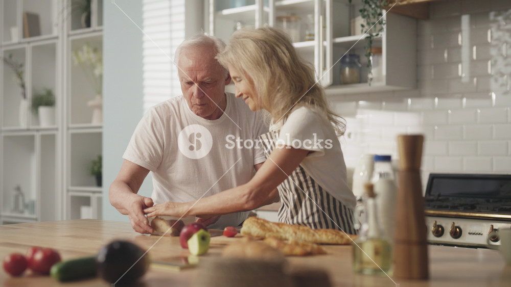 Old lady taking snack box to her mature husband in morning before working day. Careful wife cooking healthy meal for aged man, diet for stay