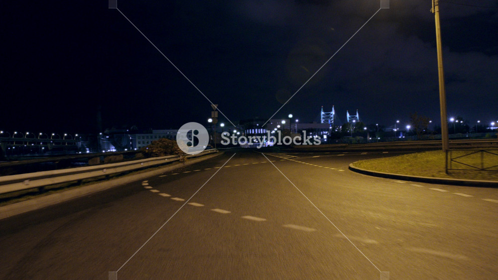 Rear window view on city outskirts in night, riding auto on empty roads. Urban areas of residential district, enjoy urbanistic landscape and