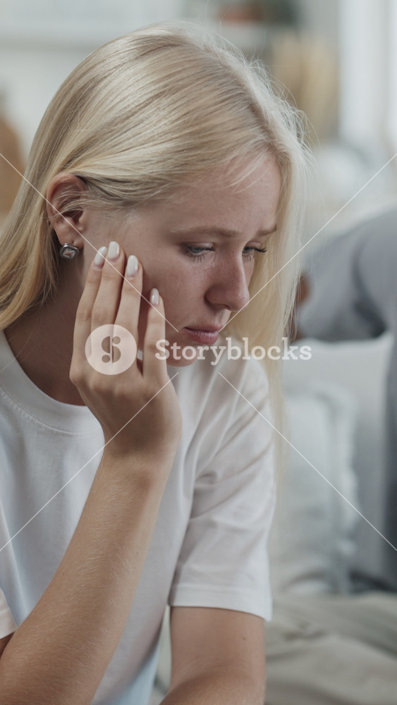 Talk about relationship, breakup or divorce, black man talking with beautiful crying woman. Vertical portrait of emotional blonde lady in