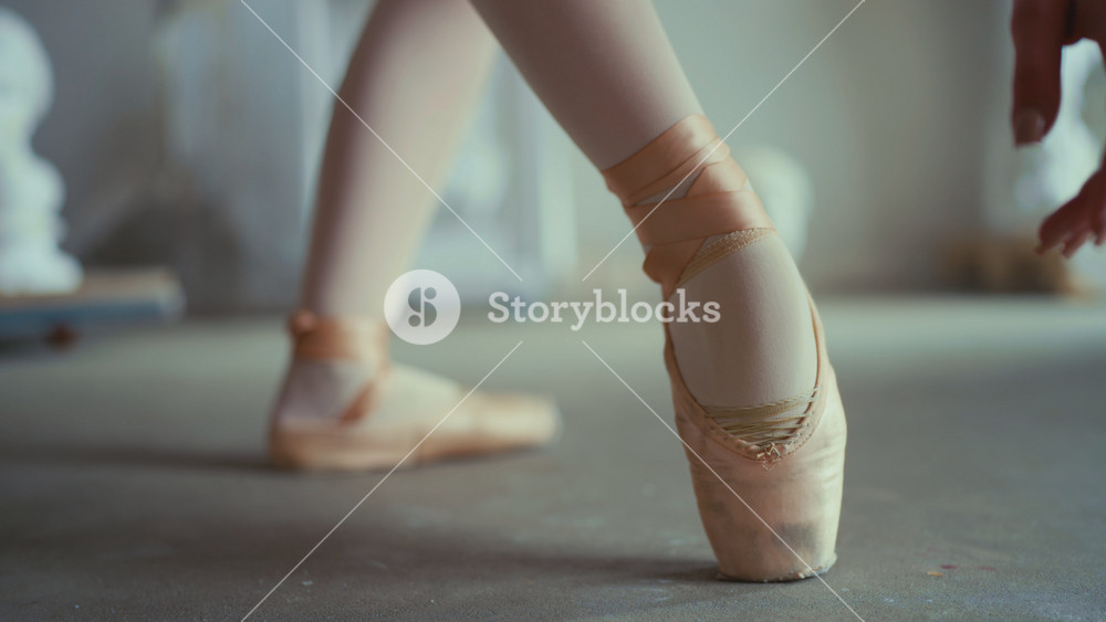 Ballet class in school of arts, closeup view of female feet in pointe shoes. Slow motion, talented ballerina rehearsing and performing