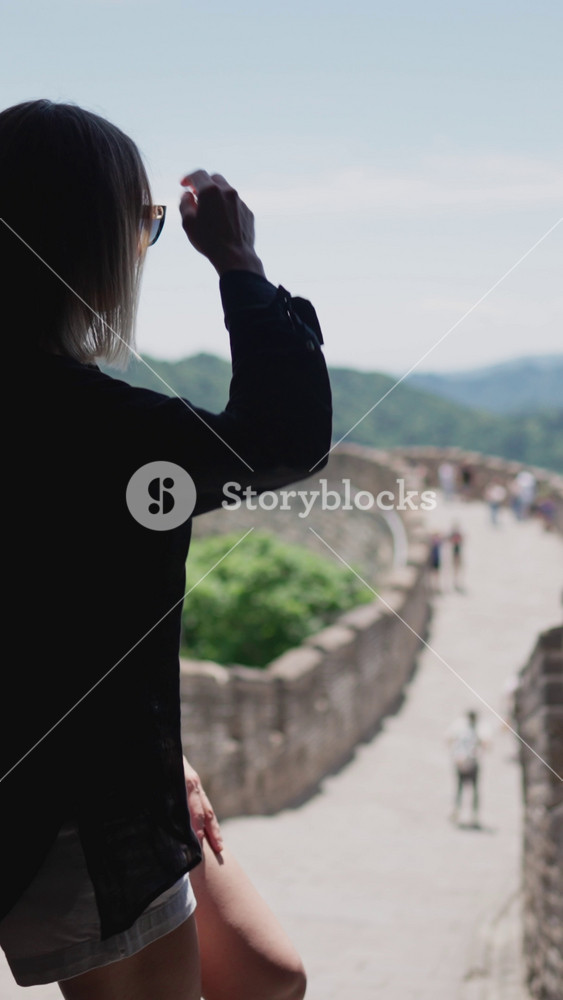 visit China and famous Great Wall of China, female tourist admiring landmark. tourist trip and excursion in ancient architectural sight