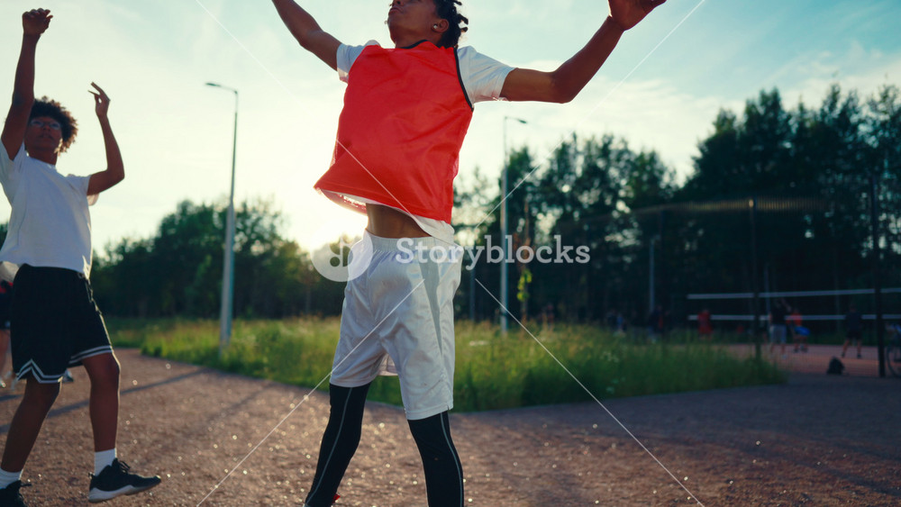 Streetball match in park, two young african guys playing basketball on street. Active sport and leisure in summer vacation, teenagers