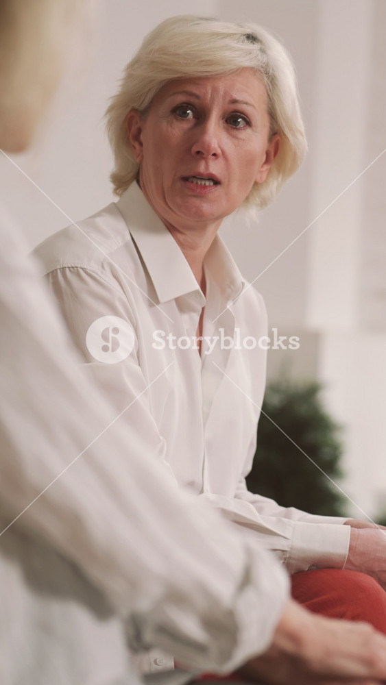 Psychological rehab after divorce, oncological disease or domestic violence. Portrait of aged blonde woman speaking about her life in group