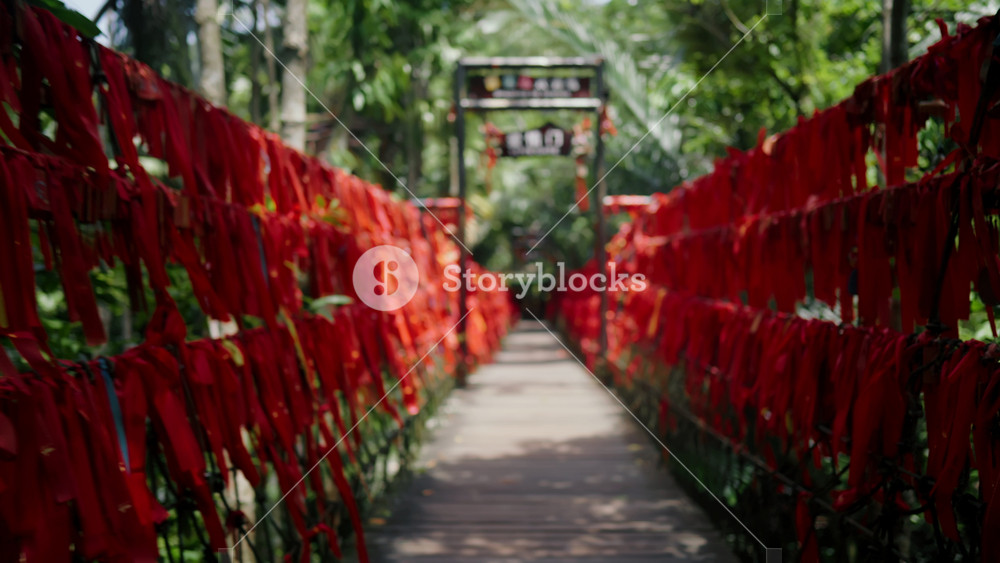 Popular tourist attraction, bridge with red tapes for wish fulfillment, travel. Rituals for luck, asian traditions and religion, walk in